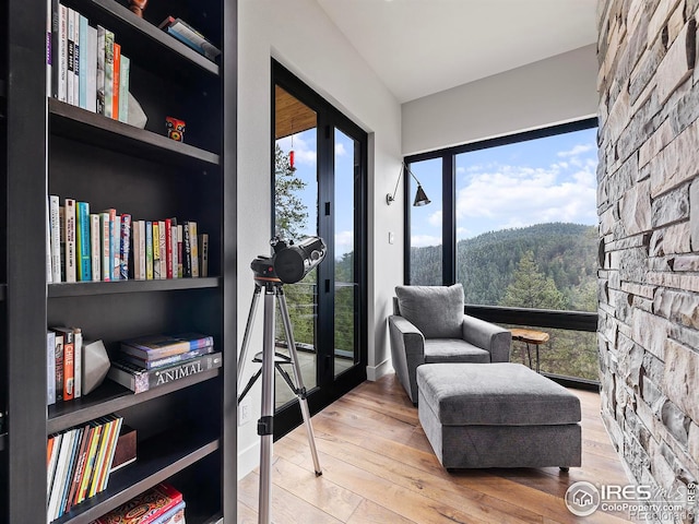 living area with built in shelves and light wood-type flooring