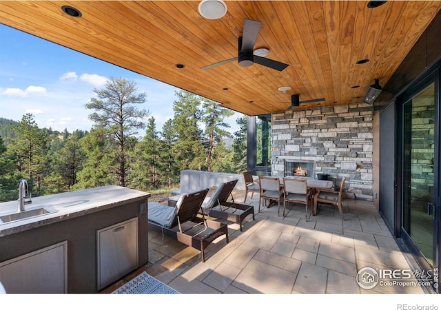 view of patio / terrace with ceiling fan, sink, and an outdoor living space