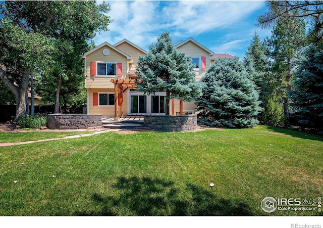 view of front of house with a patio and a front yard