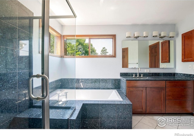 bathroom with shower with separate bathtub, tile patterned floors, and vanity