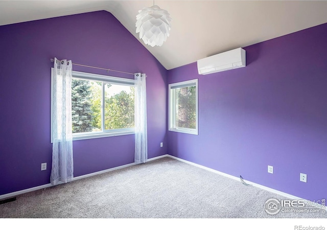 unfurnished room with a wall mounted air conditioner, carpet floors, and vaulted ceiling