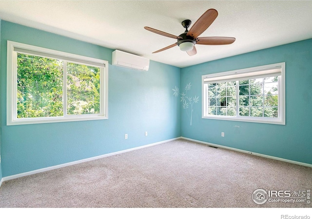 carpeted spare room with a wall mounted AC and ceiling fan