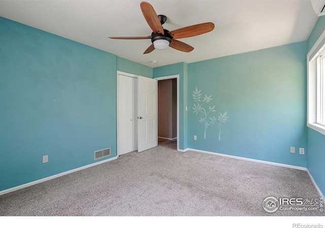 unfurnished bedroom featuring carpet flooring, a closet, and ceiling fan