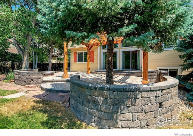 view of patio / terrace featuring an outdoor fire pit