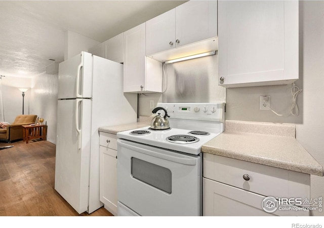 kitchen with white cabinetry, white electric stove, and light hardwood / wood-style floors