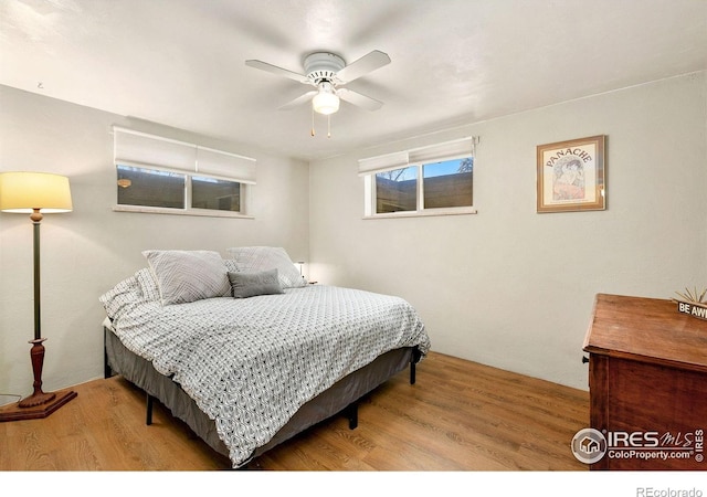 bedroom with light wood-type flooring and ceiling fan