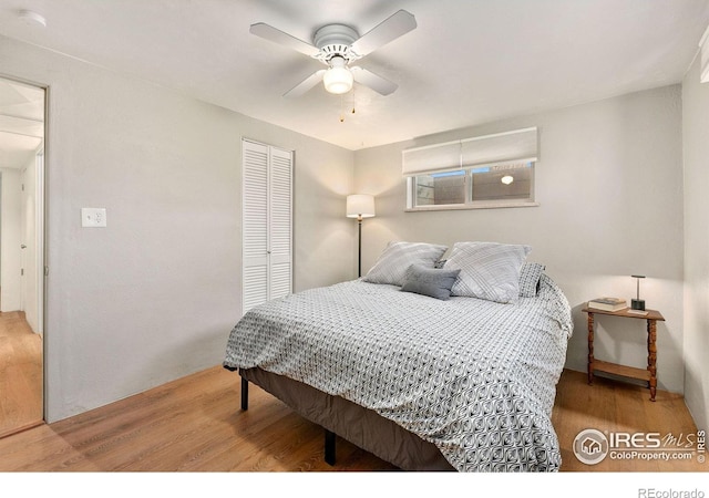 bedroom featuring ceiling fan, hardwood / wood-style flooring, and a closet