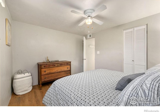 bedroom featuring ceiling fan, a closet, and hardwood / wood-style floors