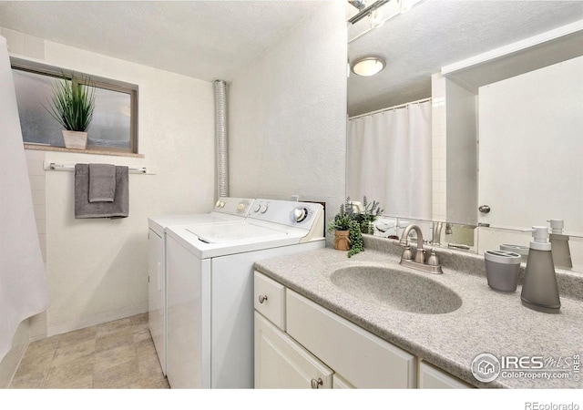 laundry room featuring light tile patterned floors, sink, and washer and dryer