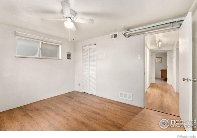 spare room with ceiling fan and hardwood / wood-style flooring