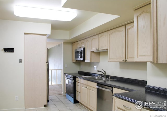 kitchen with light tile patterned floors, stainless steel appliances, sink, and light brown cabinets