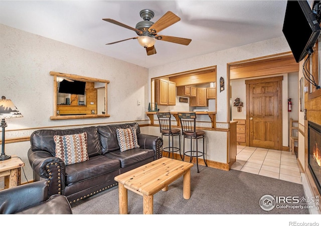 tiled living room featuring ceiling fan