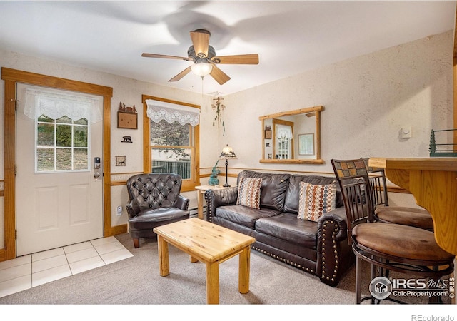 living room featuring light carpet and ceiling fan