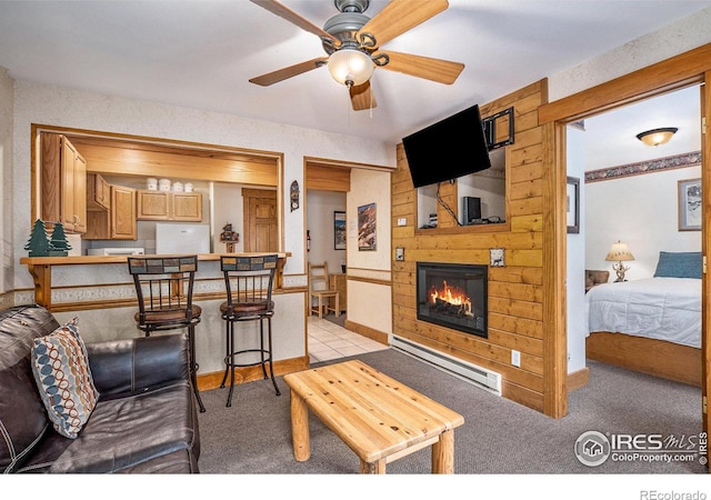 carpeted living room featuring a fireplace, ceiling fan, and baseboard heating