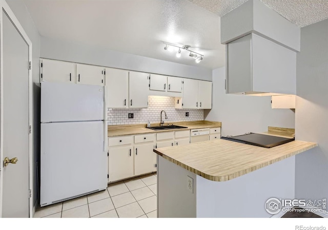 kitchen featuring kitchen peninsula, white appliances, sink, white cabinets, and light tile patterned flooring