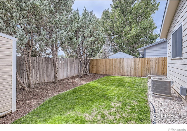 view of yard with a fenced backyard and central air condition unit