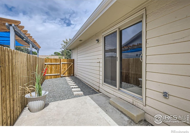 view of patio / terrace featuring fence and a pergola