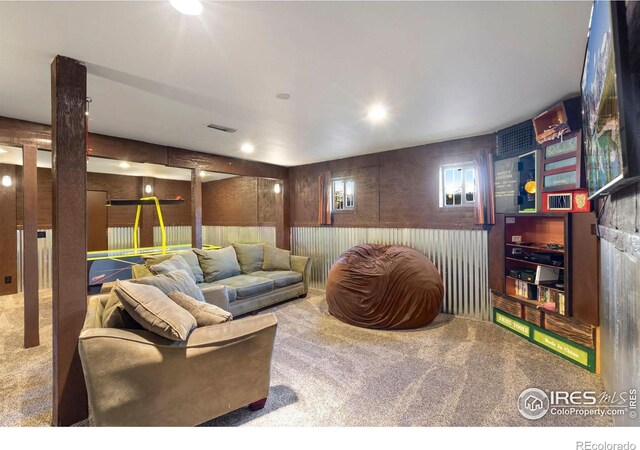 living room with wood walls and carpet