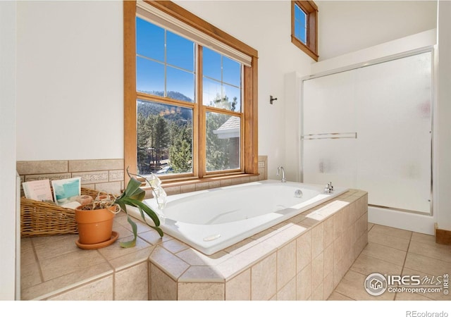 bathroom with separate shower and tub and tile patterned flooring