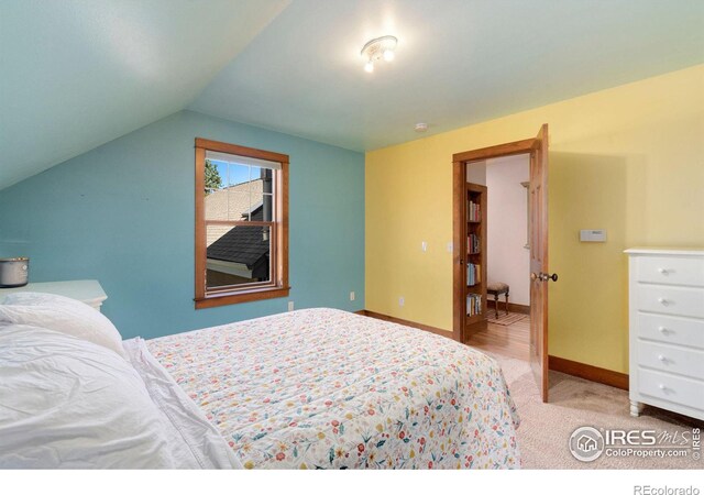 carpeted bedroom with vaulted ceiling