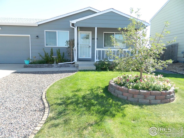 view of front of property with a front yard and a garage