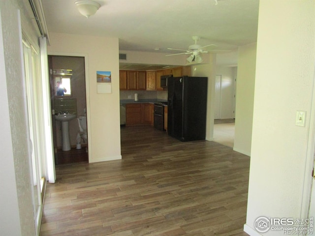 unfurnished living room with ceiling fan and hardwood / wood-style floors