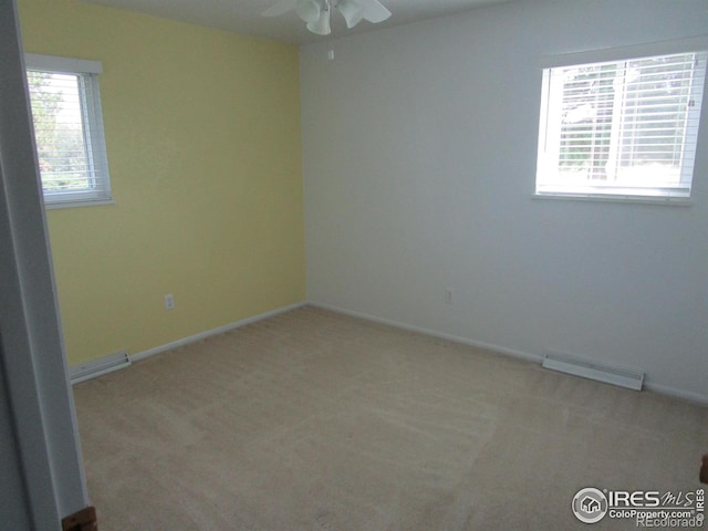 carpeted spare room with ceiling fan