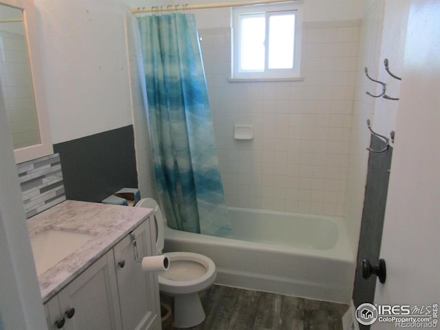 full bathroom with toilet, decorative backsplash, shower / tub combo, hardwood / wood-style flooring, and vanity