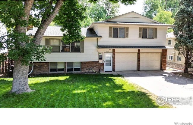 tri-level home with a garage and a front yard