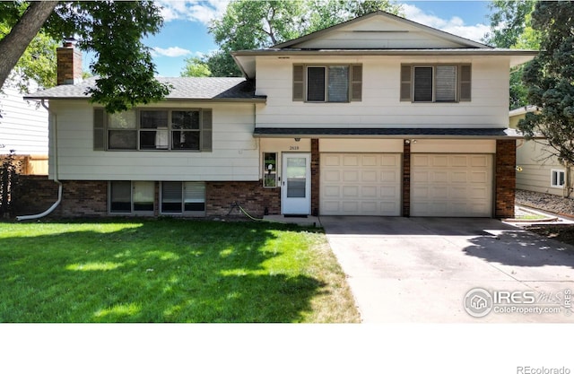 tri-level home featuring a front lawn and a garage