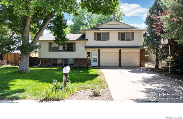 split level home with a front lawn and a garage