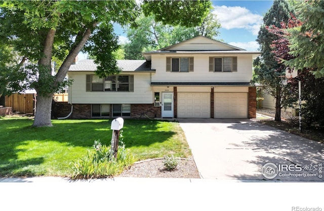 tri-level home with a front yard and a garage