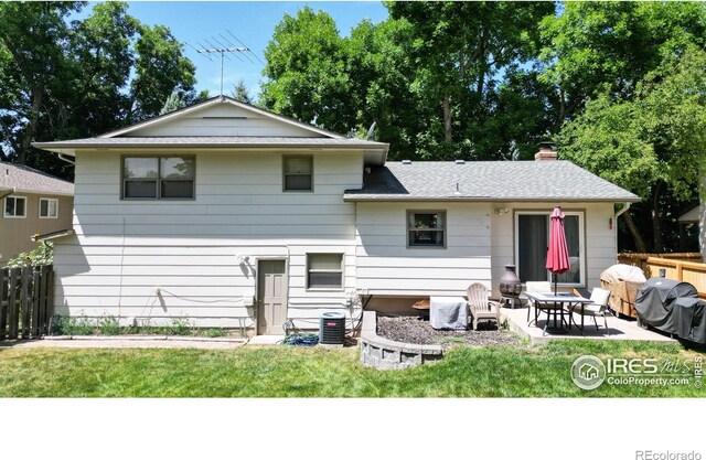 back of property featuring a lawn and a patio