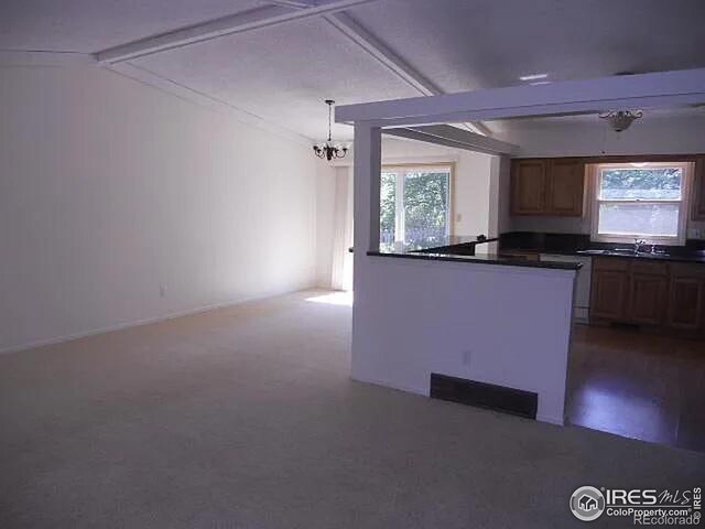 kitchen with sink, a chandelier, and a healthy amount of sunlight