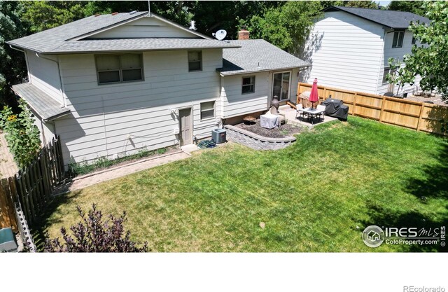 back of house featuring a yard, a patio, cooling unit, and an outdoor living space