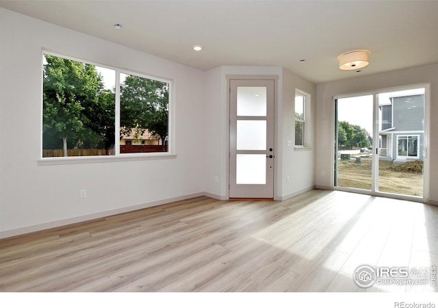 unfurnished room with light wood-type flooring