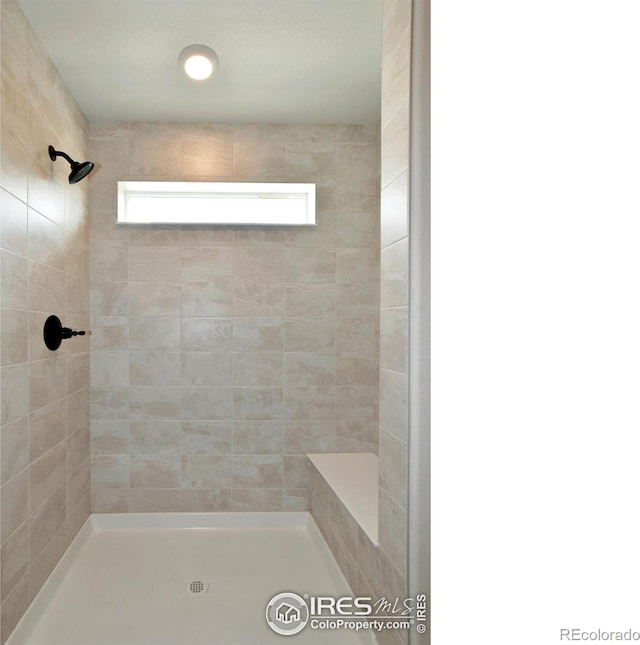 bathroom with a tile shower