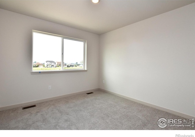 empty room featuring light colored carpet