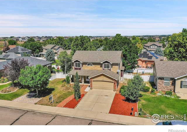 view of front of house featuring a garage and a front lawn