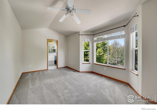 carpeted empty room with lofted ceiling and ceiling fan