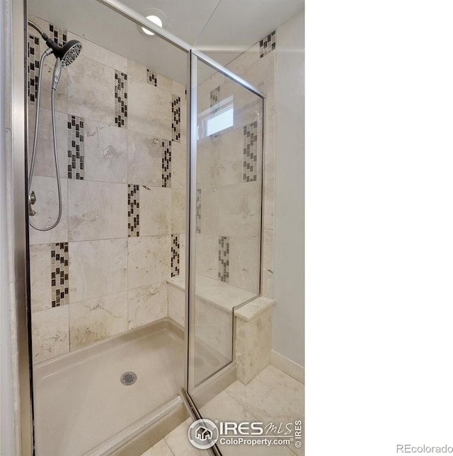 bathroom with tile patterned floors and a shower with shower door