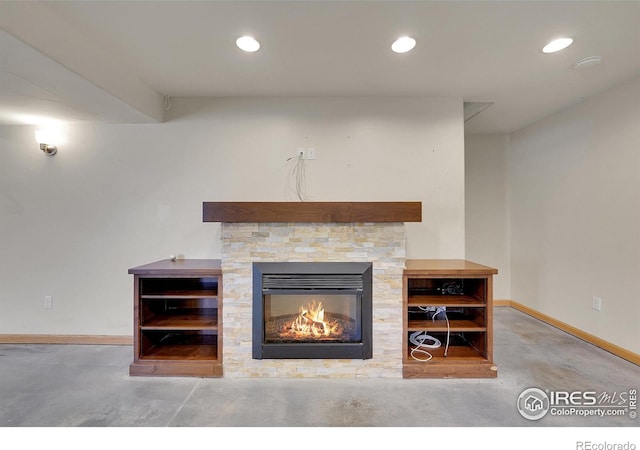 interior details with a stone fireplace and concrete floors