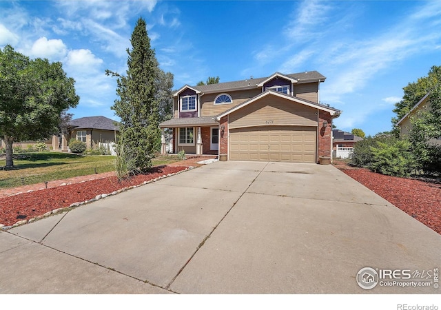 view of property featuring a front lawn and a garage