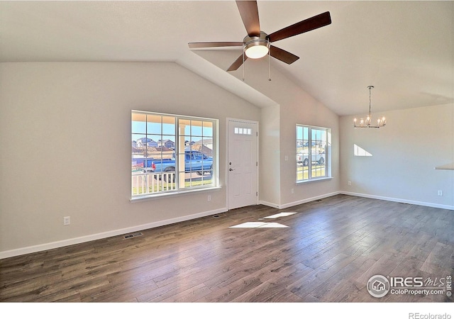 spare room with dark hardwood / wood-style flooring, ceiling fan with notable chandelier, and lofted ceiling