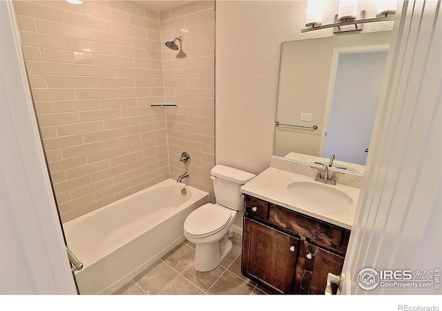 full bathroom featuring tile patterned floors, vanity, toilet, and tiled shower / bath