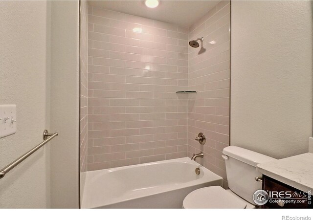 full bathroom with vanity, toilet, and tiled shower / bath