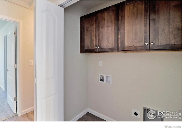 laundry area featuring hookup for a washing machine, cabinets, and light wood-type flooring