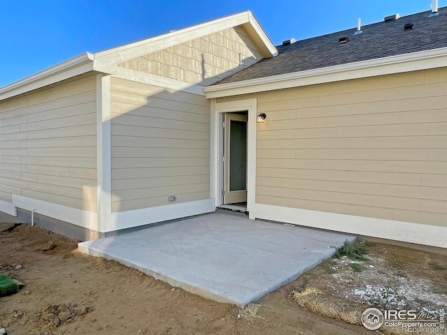 view of exterior entry featuring a patio