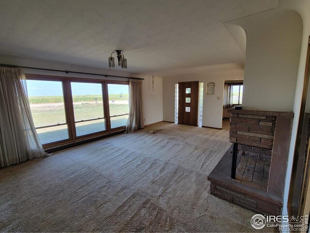 unfurnished living room featuring light colored carpet