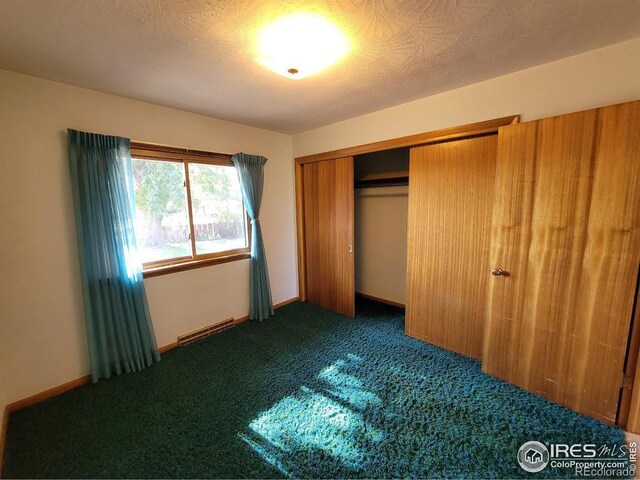 unfurnished bedroom with carpet flooring and a closet